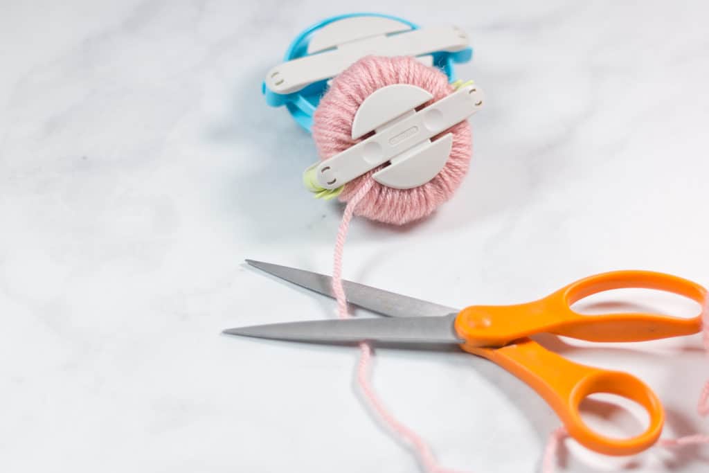 Cutting Yarn on a Pom Pom Maker Clover