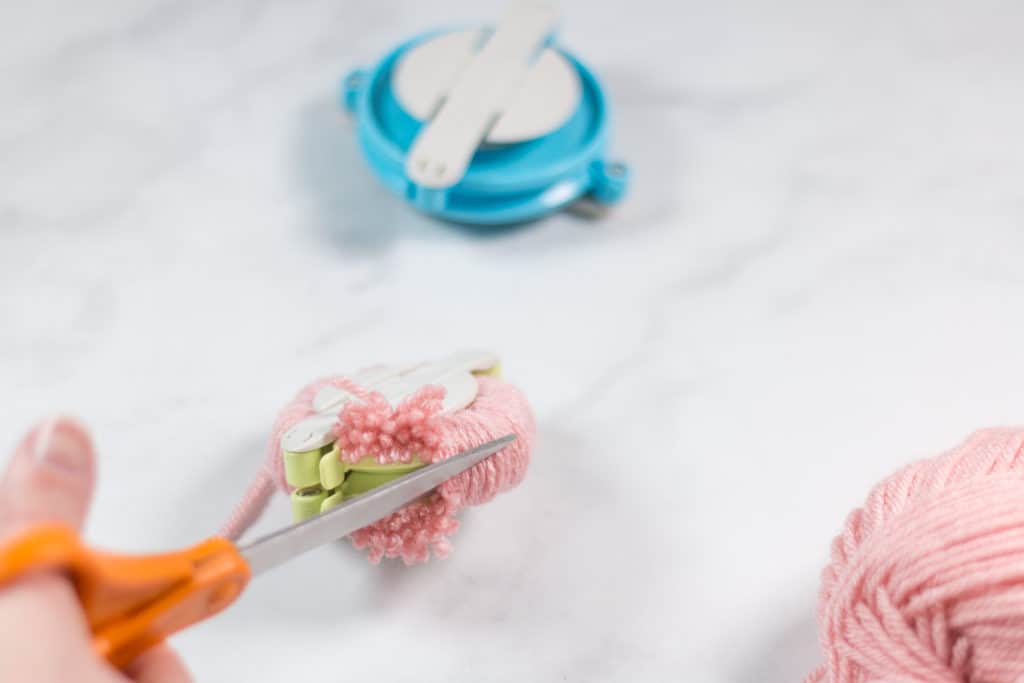 Cutting Yarn on a Clover Pom Pom Maker